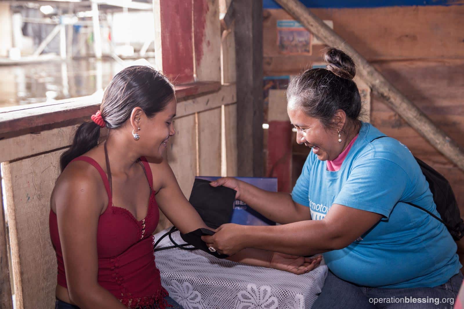  Nadia takes a woman’s blood pressure. You can see her love of helping others on her face.