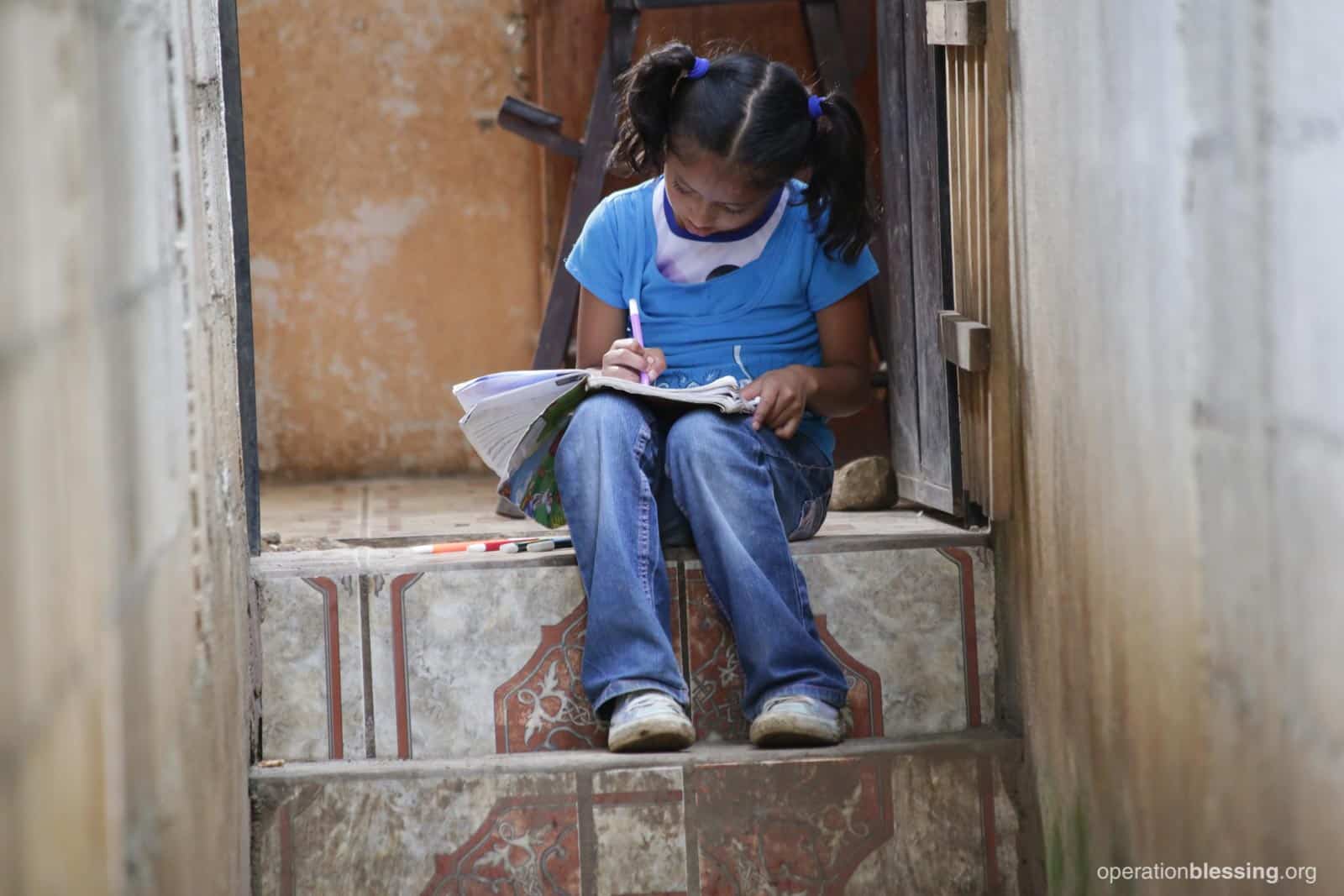 Dulce strains to read a book before her operation.