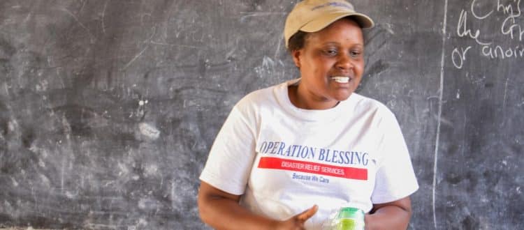 An OB worker teaching villagers in Kenya about fighting Malaria.