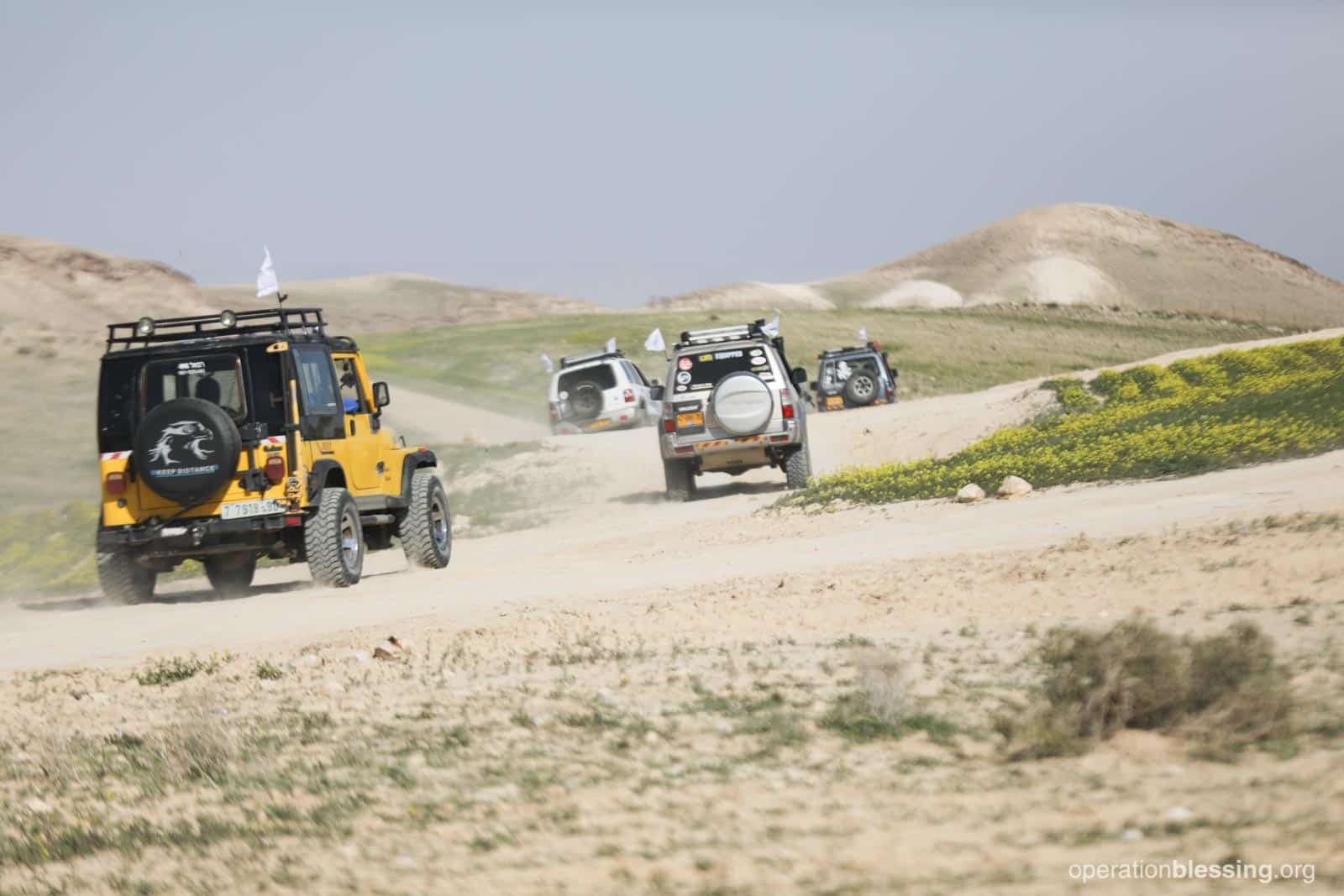 Four by fours delivering aid to Bedouins in the Judean Desert.