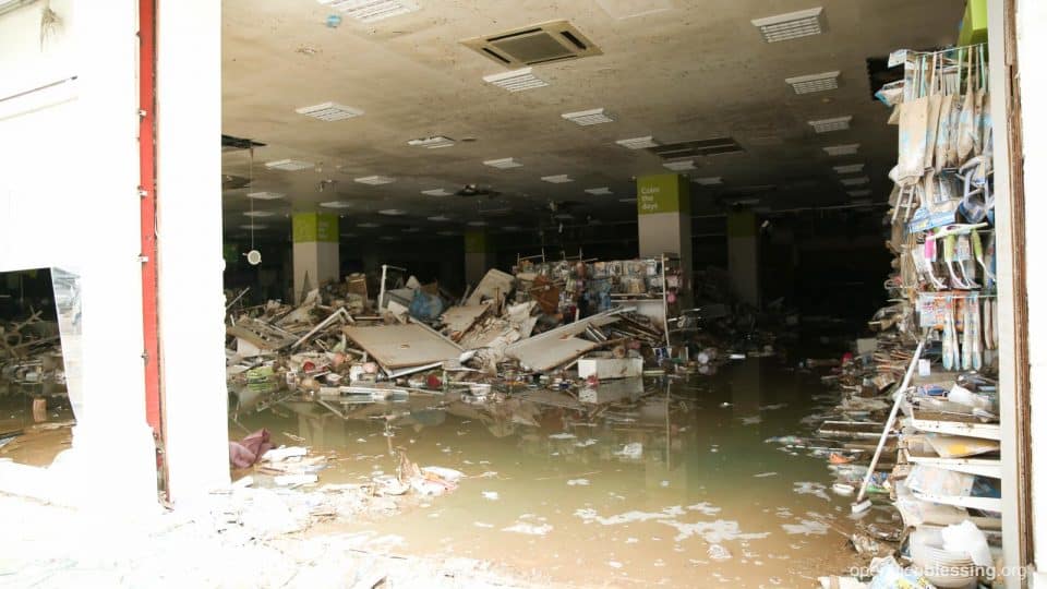 A flooded, mud-filled building in need of recovery.