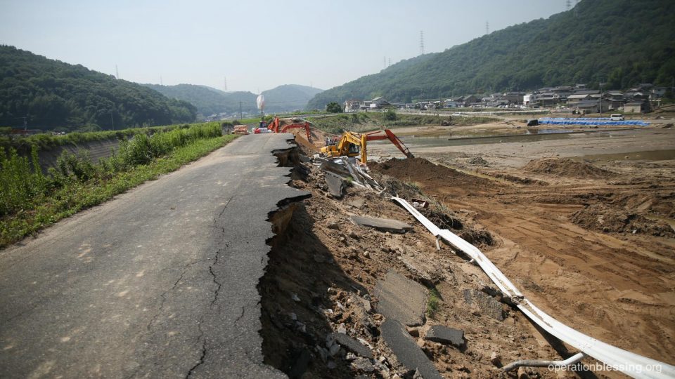 A road destroyed by flooding.