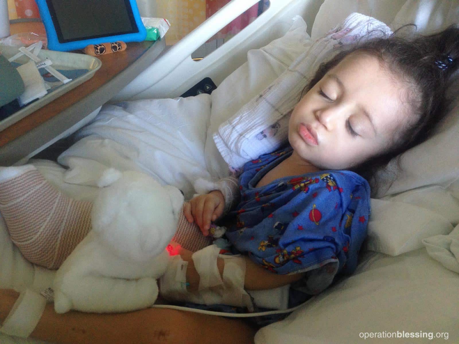 Daniella lying in a hospital bed, suffering from a genetic disorder.