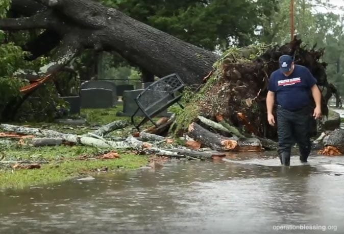 An Operation Blessing worker walks through a scene of flooding and devastation. We are responding with relief and recovery efforts in North Carolina in the wake of Hurricane Florence.