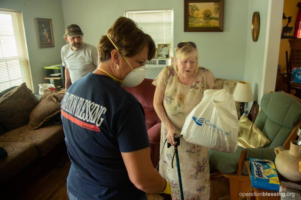 John and Crystal get help clearing flooded items from their home. 