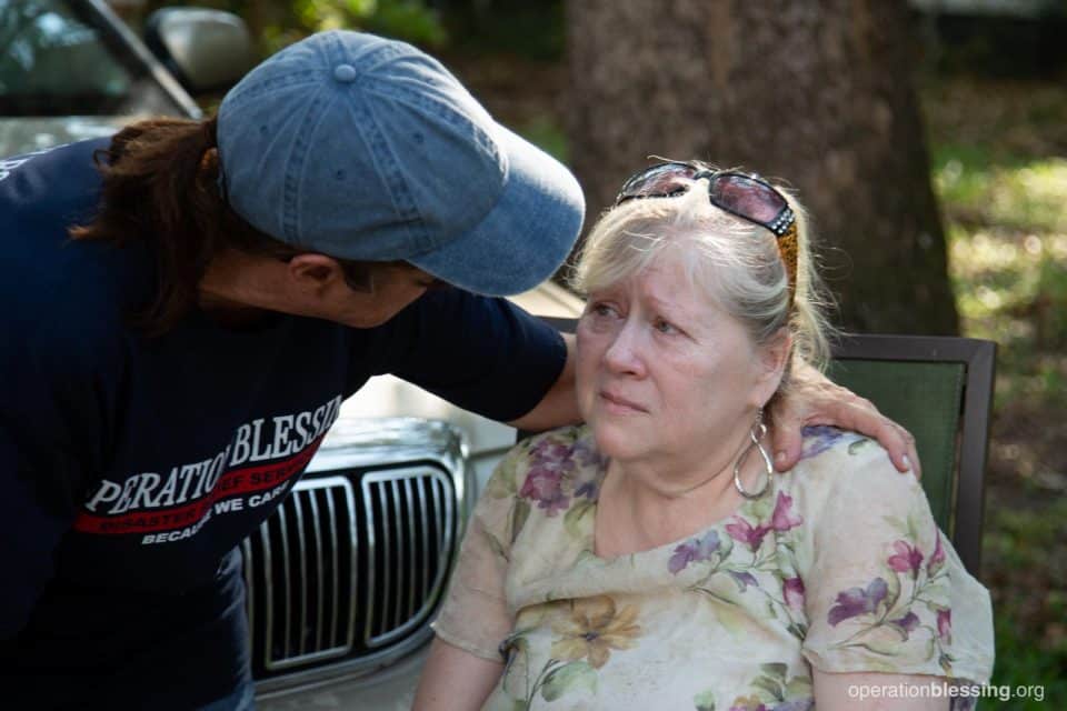 Crystal receives comfort from an Operation Blessing worker.