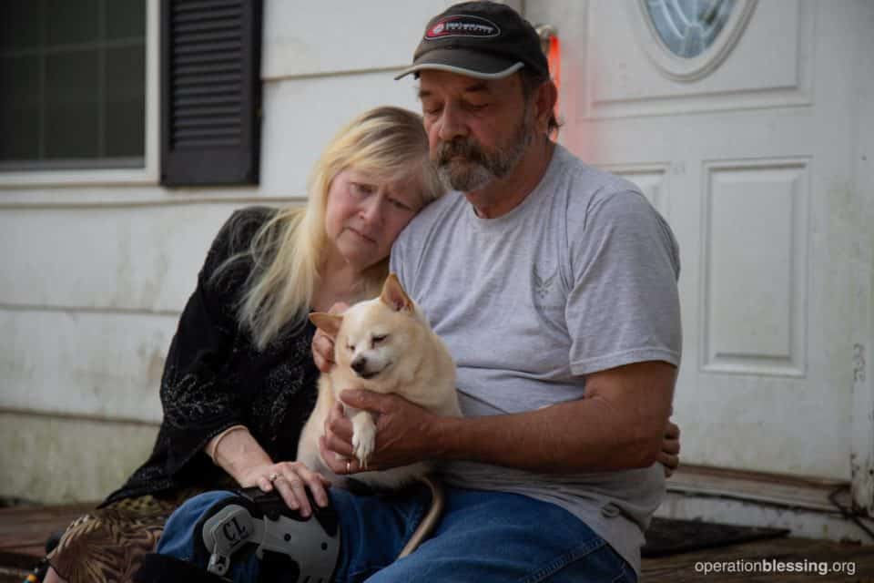 Hurricane victims and their dog, helped by Operation Blessing