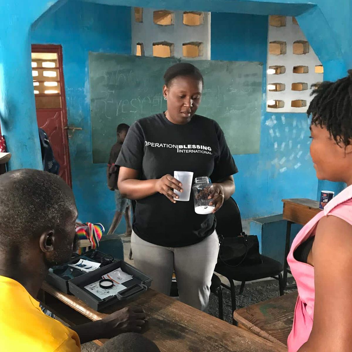 Haitian villagers being trained to use chlorine generators.