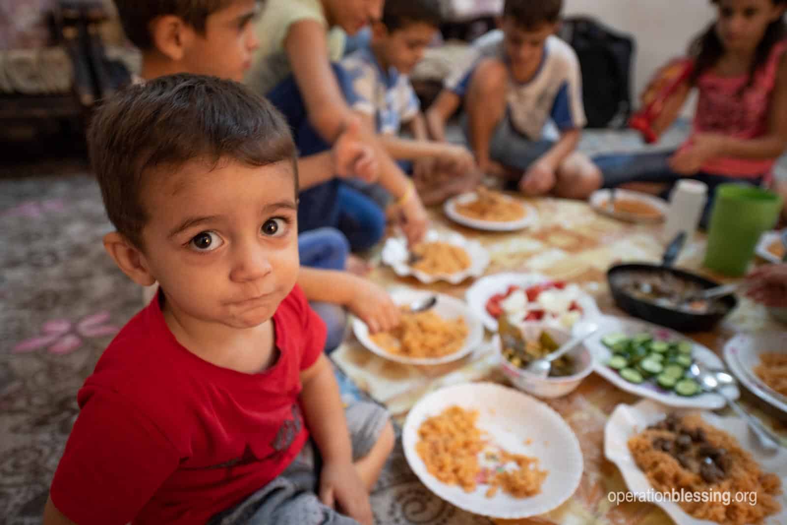 One of Wisam's sons eating dinner.