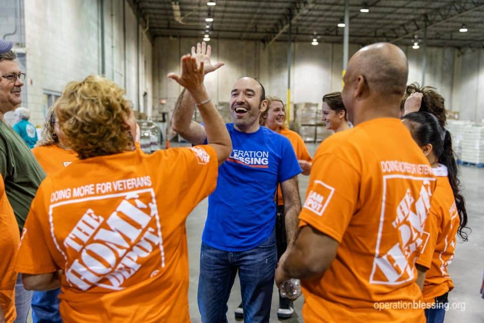 High fives between Operation Blessing and Home Depot volunteers