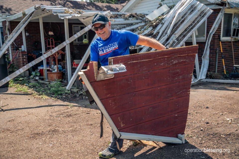 An Operation Blessing volunteer providing clean up and tornado relief.