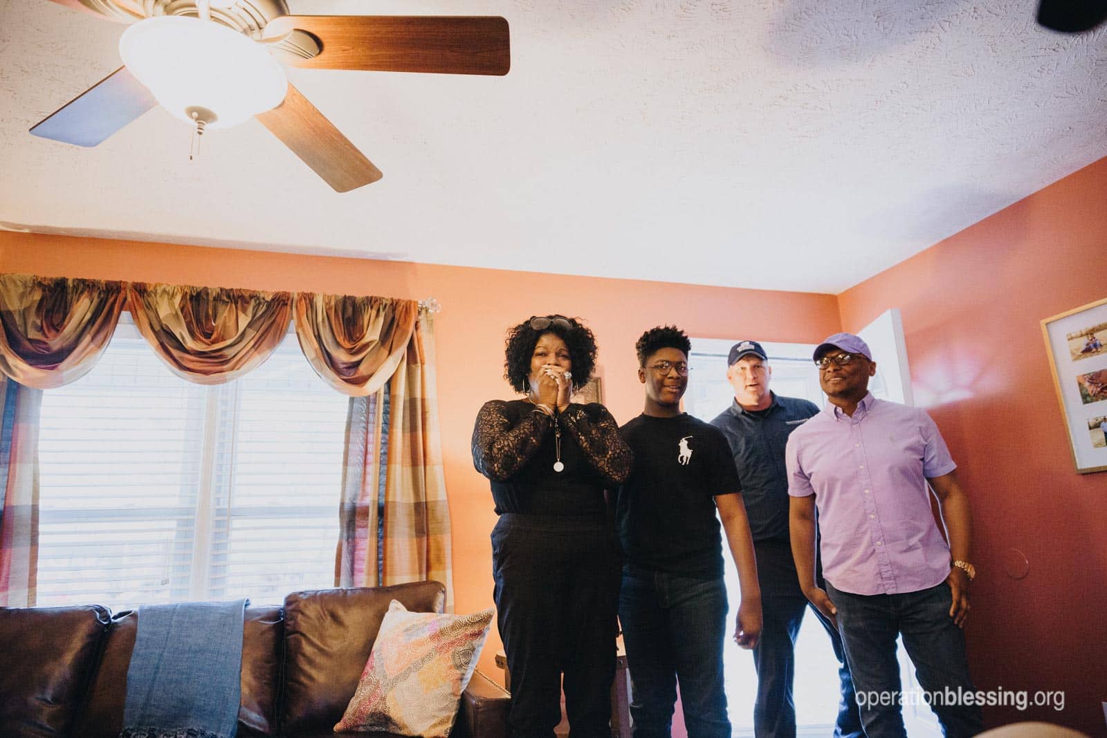 The family walks inside the home and sees the remodeled living room.