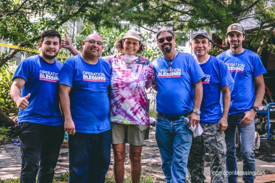 Grace surrounded by the support of Operation Blessing volunteer helpers.