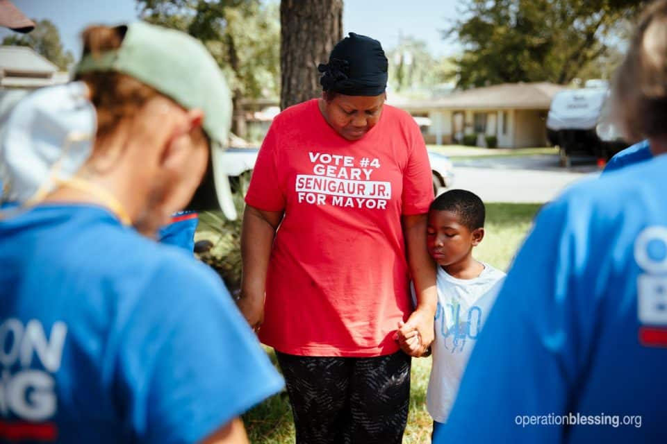 OB workers pray with Debra and Christian.