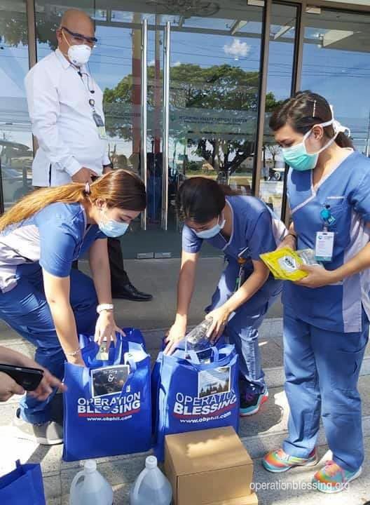 Distributing protective face masks to medical workers.