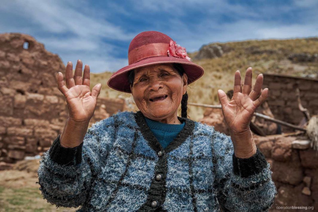 Luisa raises her hands in thanks for clean water.