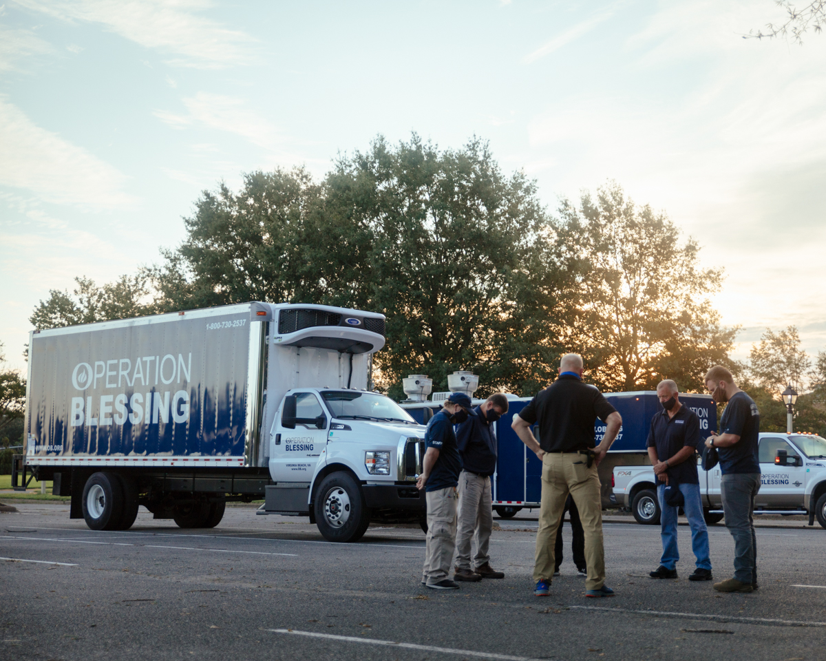 Operation Blessing disaster relief team praying before deploying to Hurricane Laura