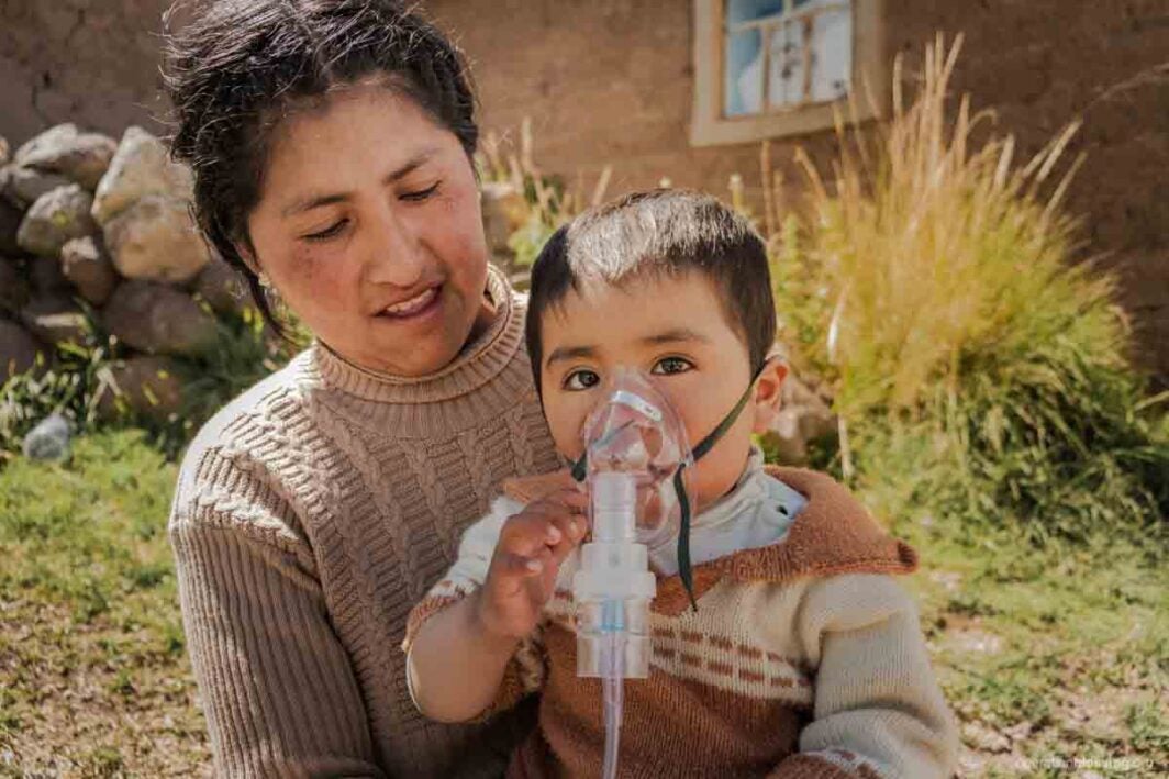 child getting breathing help from clinic in peru