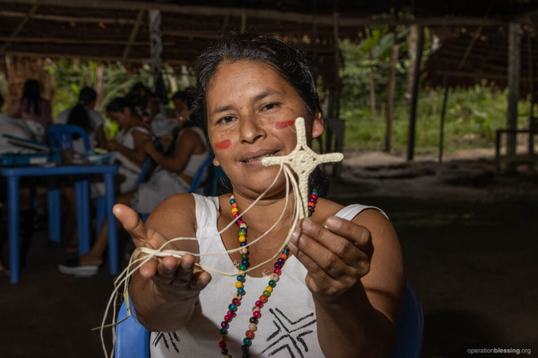 Artisan in Peru with cross